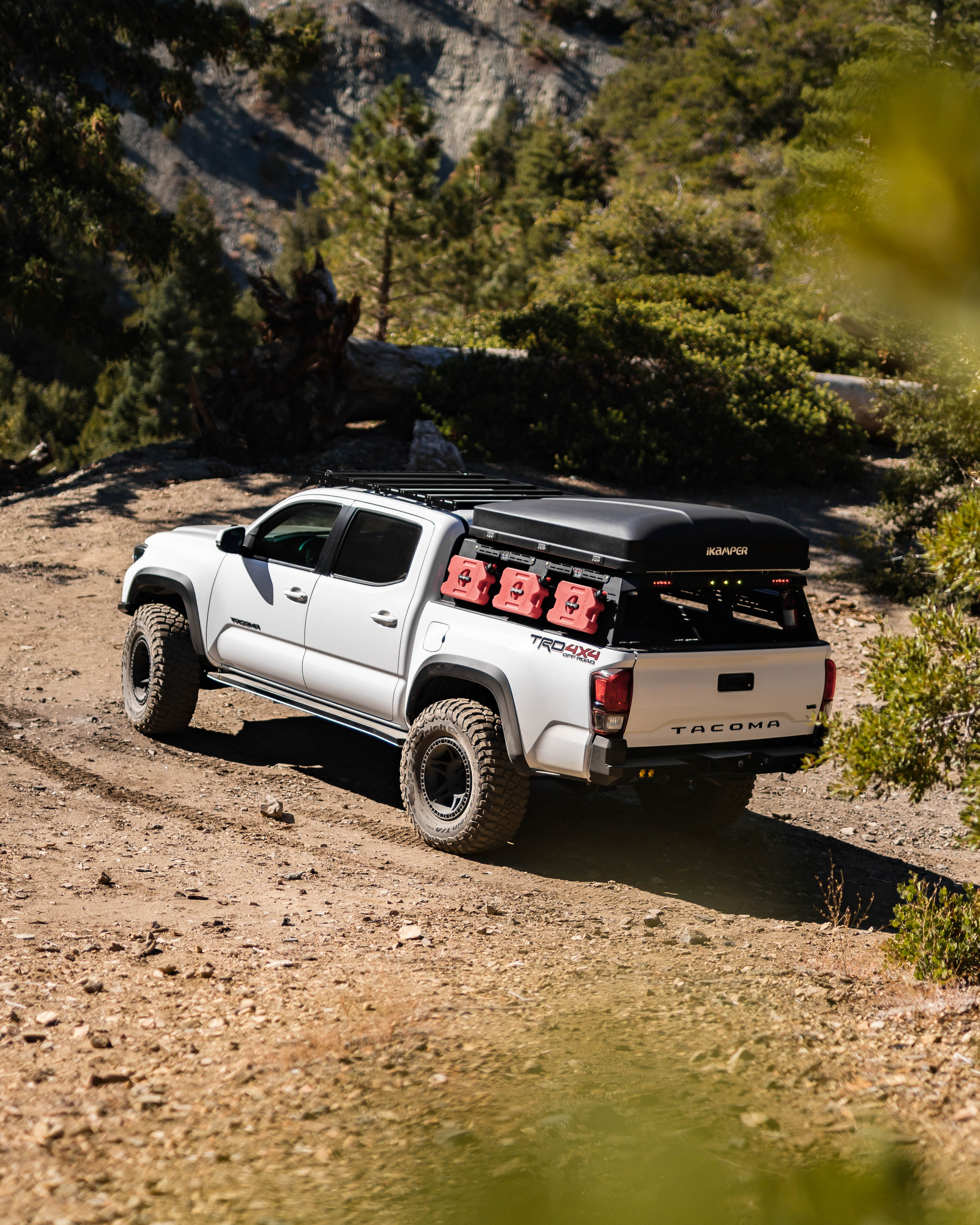 Toyota Tacoma equipped with Saints Offroad bed rack on an off-road trail