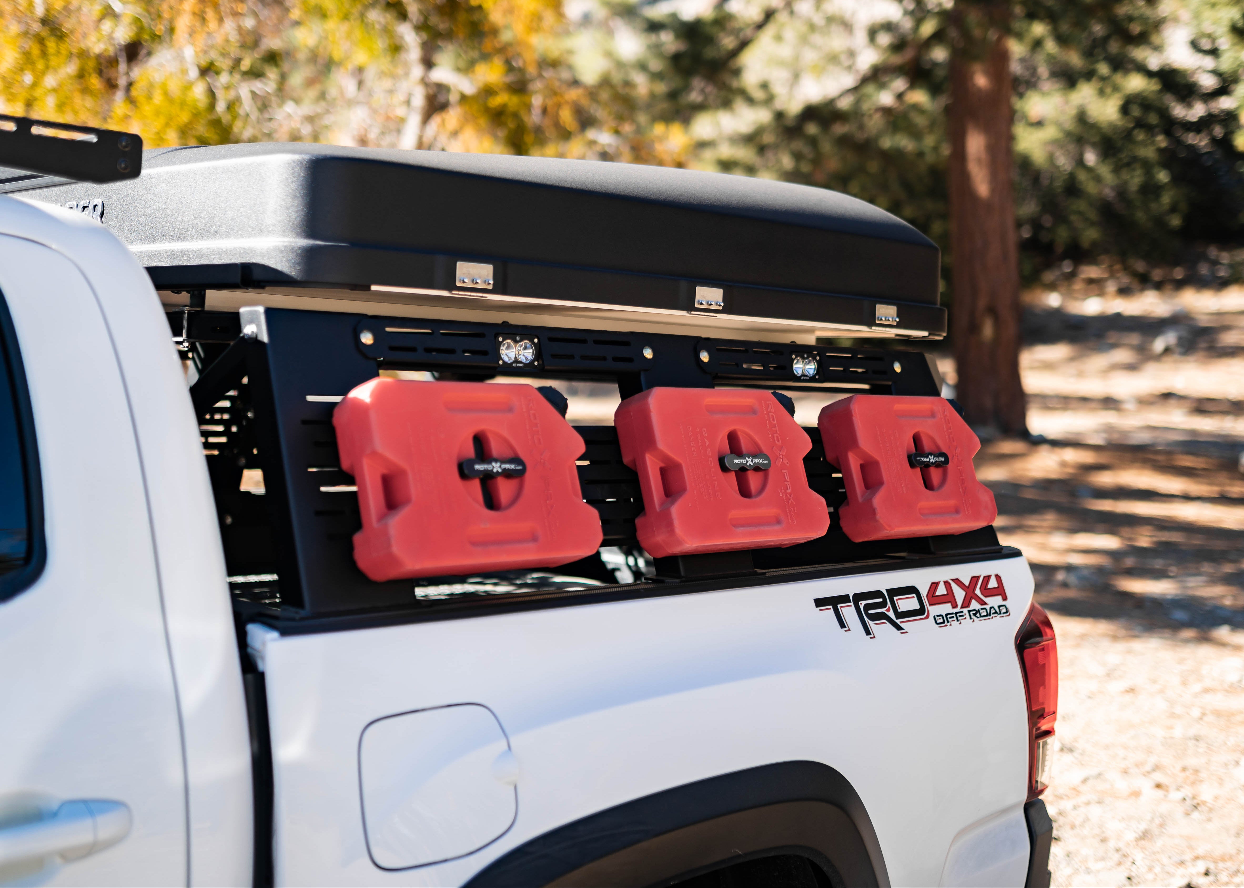 Close-up of Saints Offroad Tacoma bed rack side panel with mounted accessories