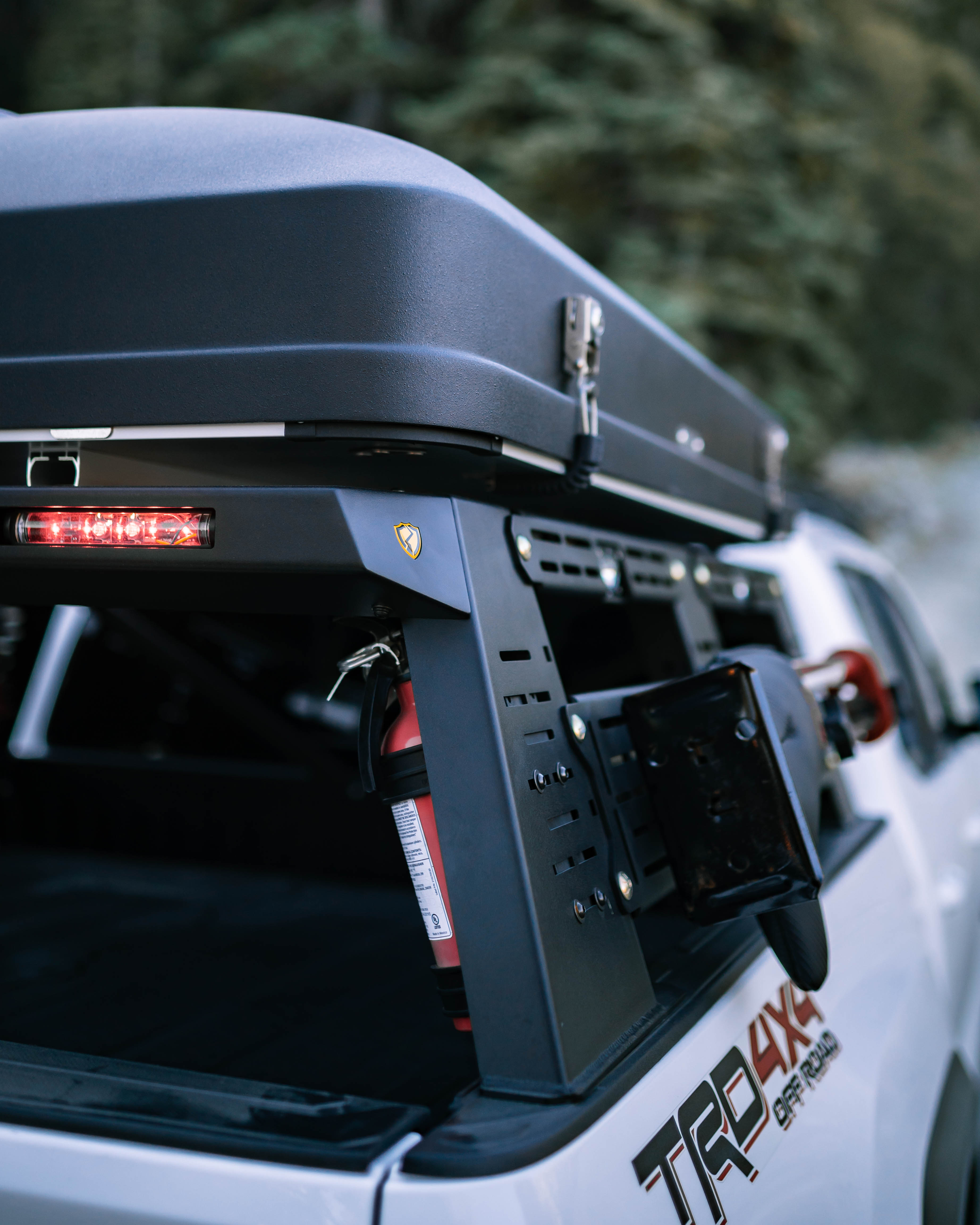 Rear view of Saints Offroad Tacoma bed rack with chase light housing and rooftop tent