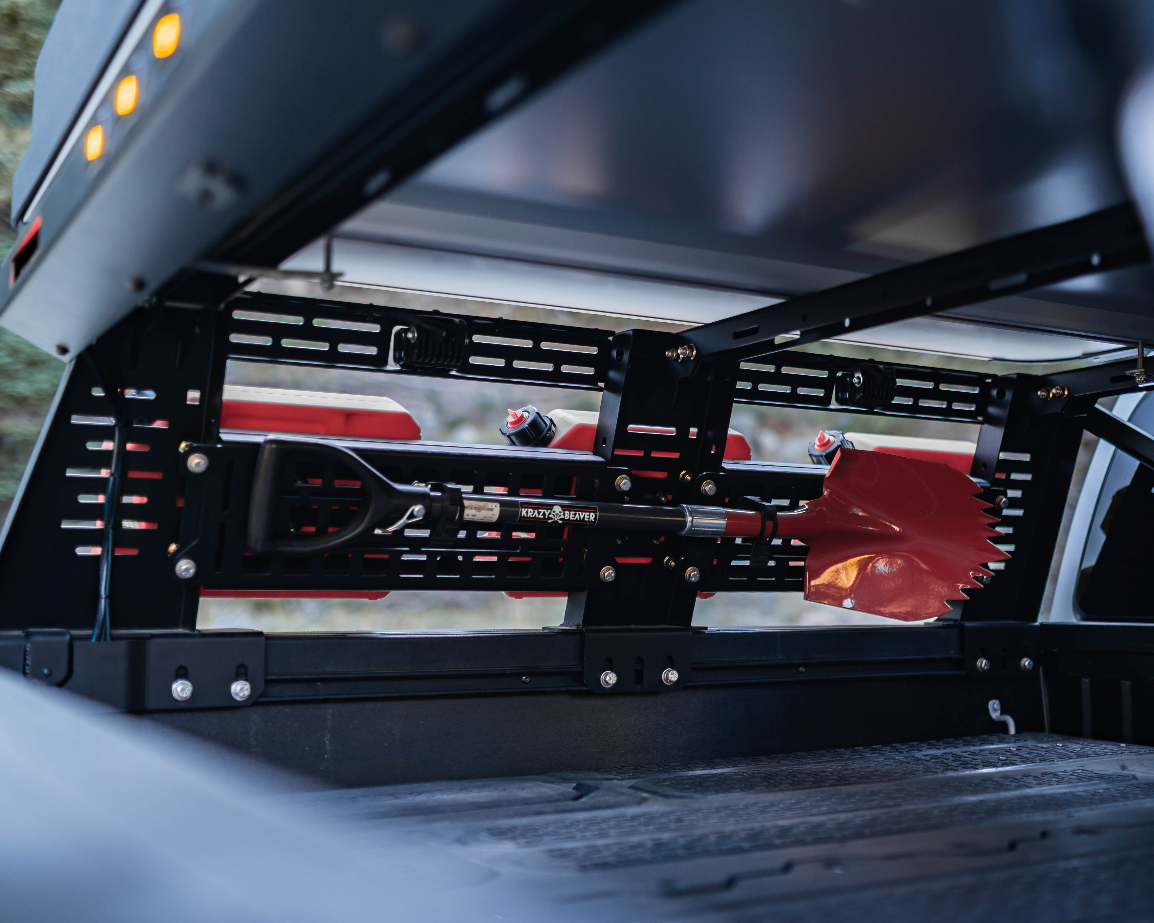 Interior view of Saints Offroad Tacoma bed rack with accessory mounting panels and lighting