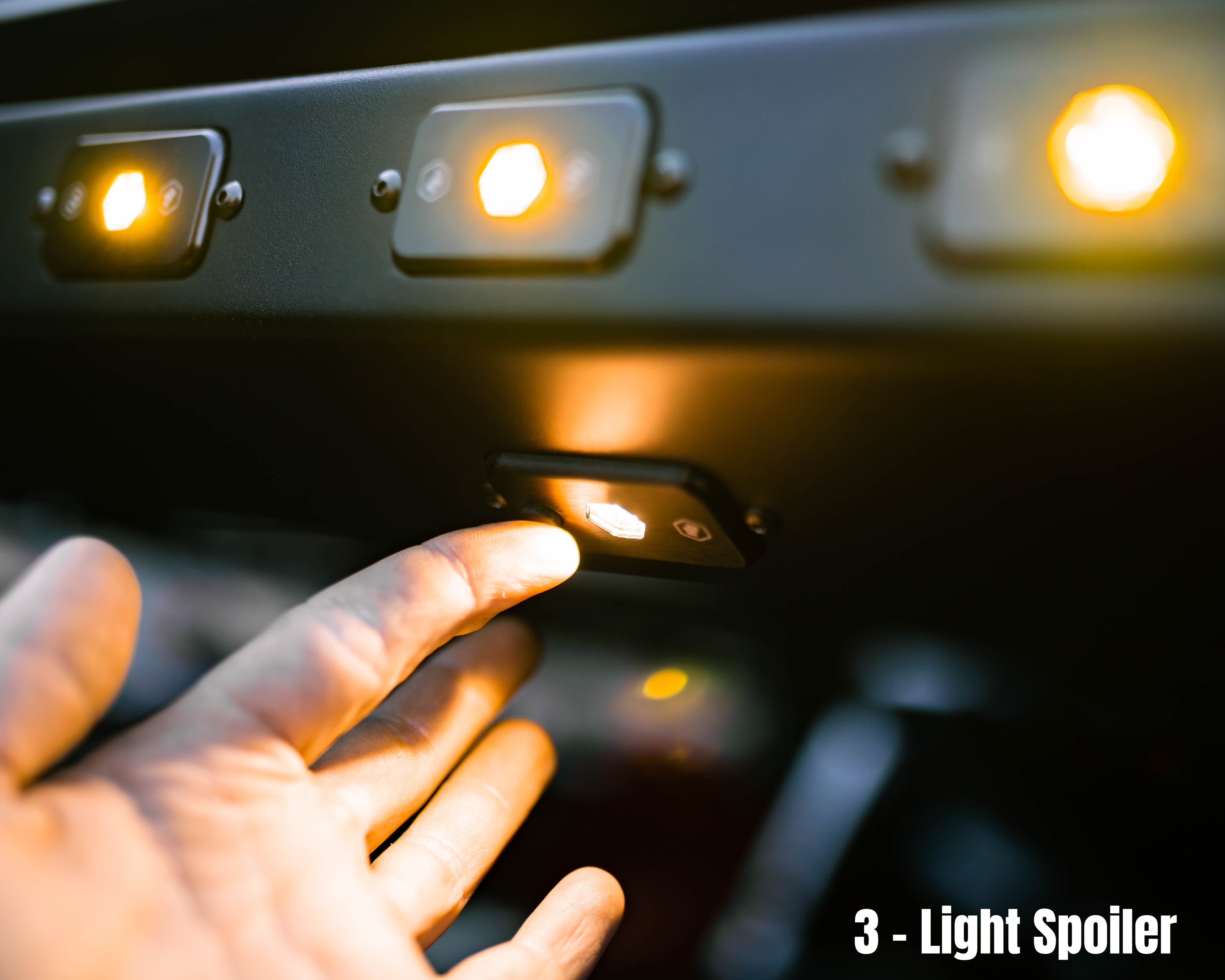 Close-up of rear lighting mounted to the Saints Offroad Tacoma bed rack