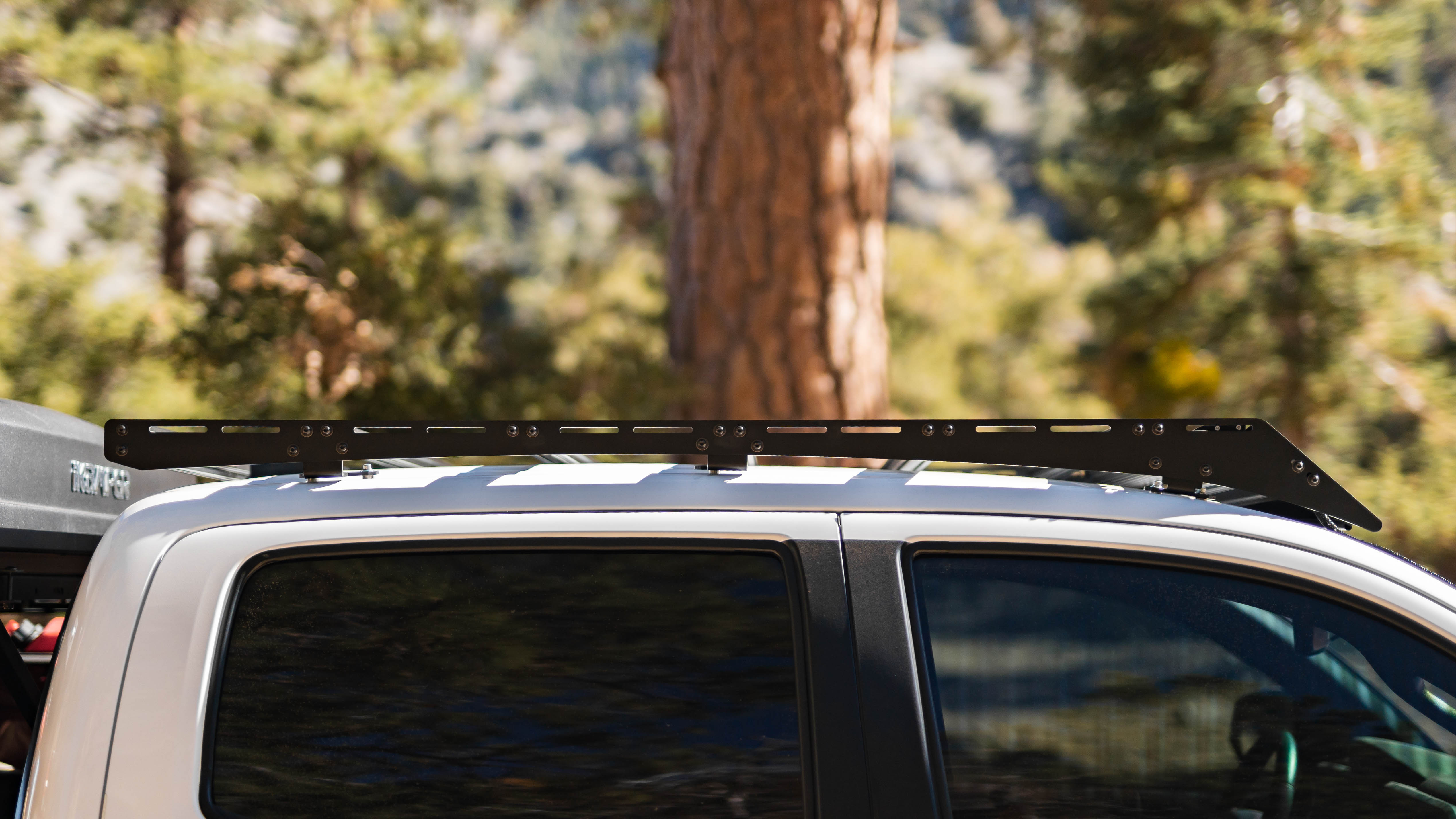 Close-up side view of Saints Offroad roof rack installed on a Toyota Tacoma